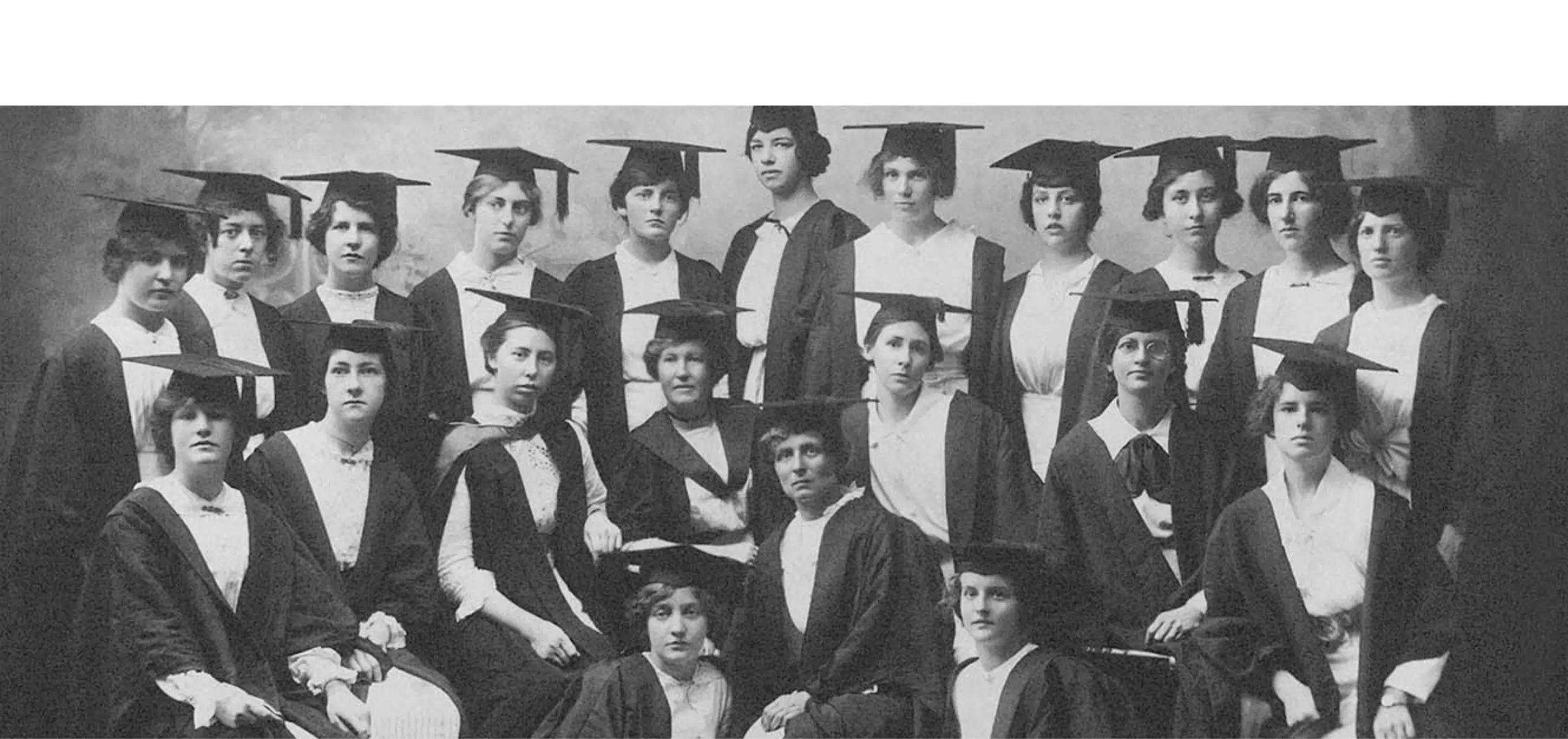 A black and white photo of a group of people in academic gowns.