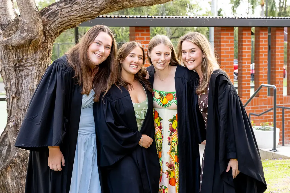Four students in academic gowns representing the four student leaders at The Women's College.