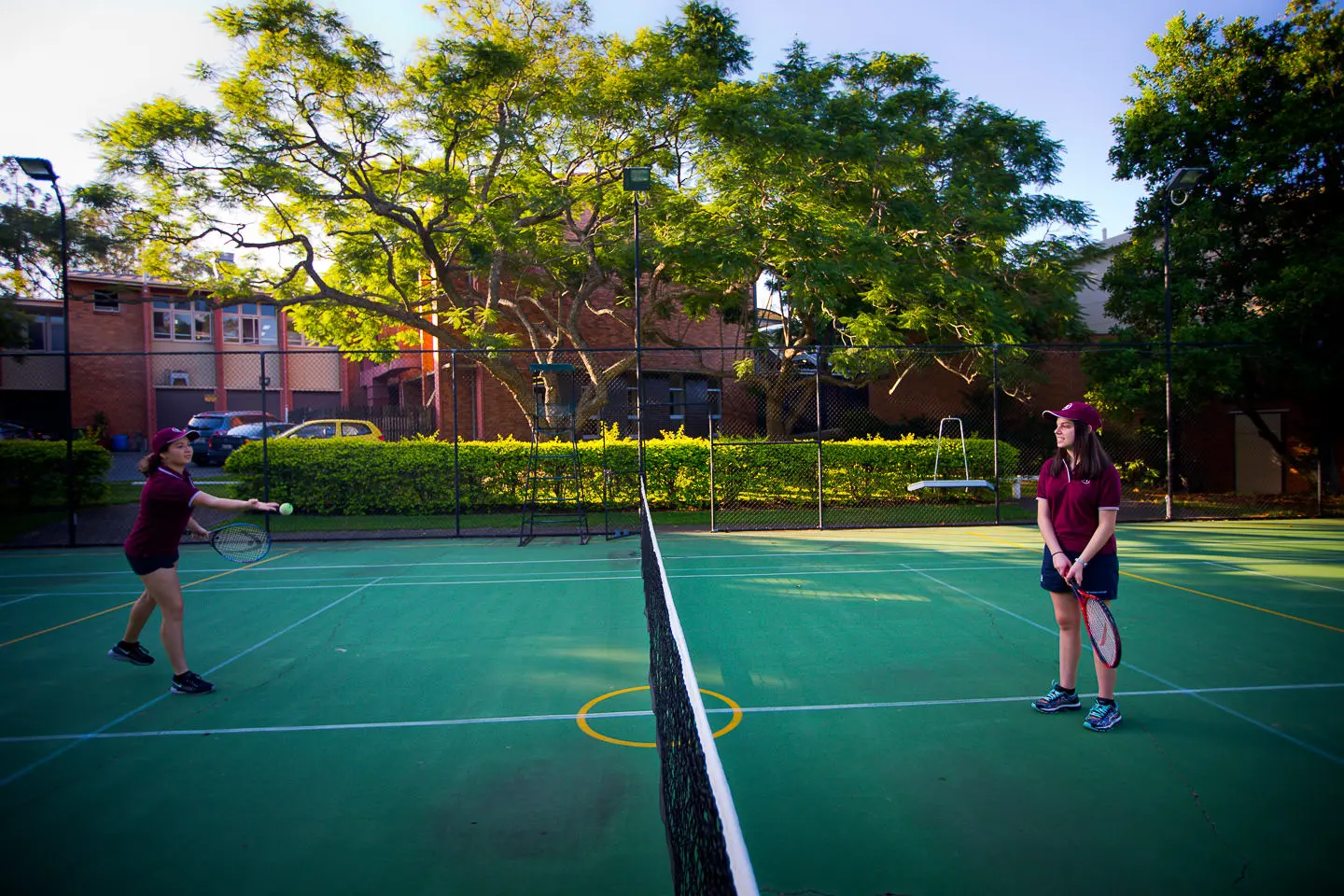 A photo of a tennis court with two tennis plays on either side of the net.