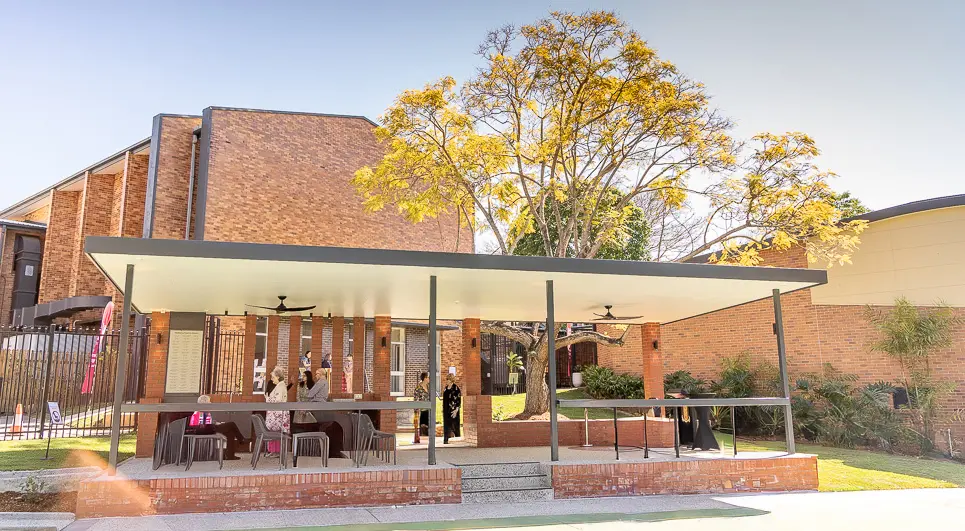 A photo of a pavilion with people standing around inside.